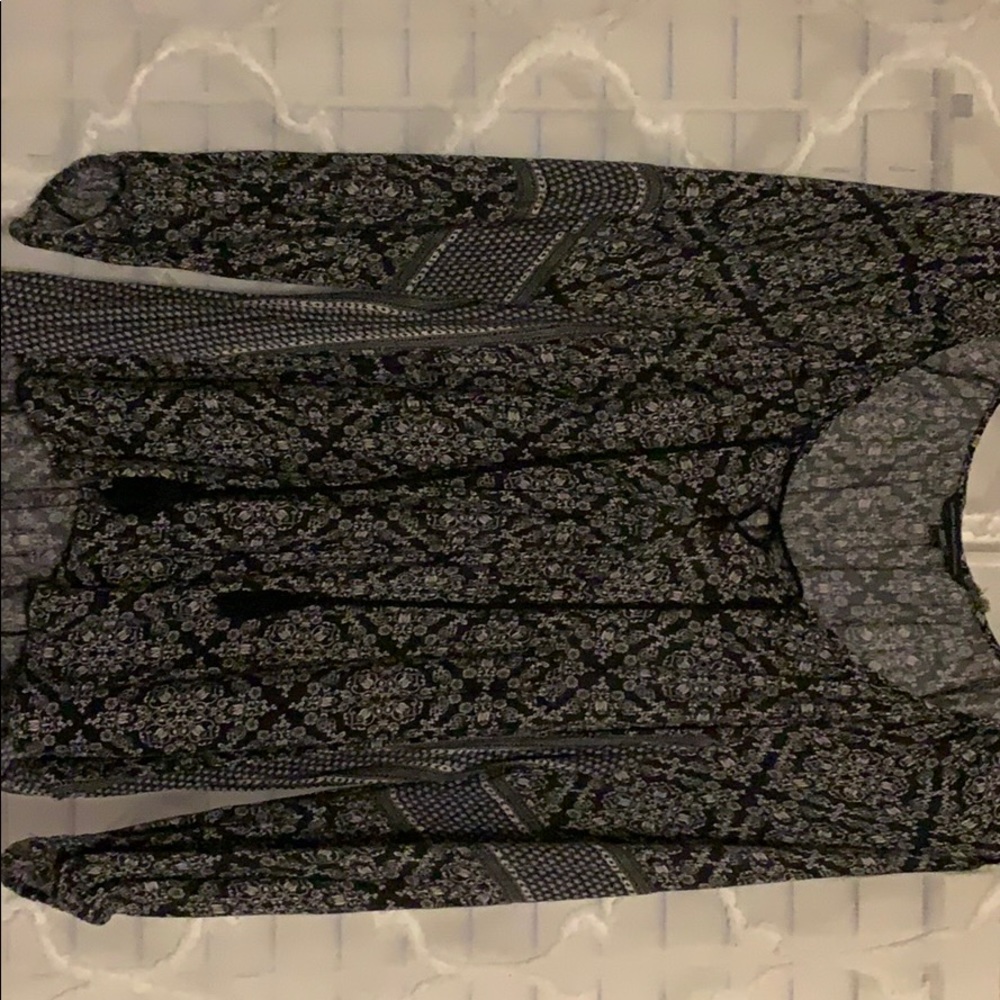 Printed long sleeve blouse. Tassels at neck line.